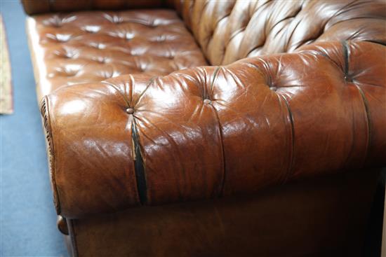 A brown leather buttoned Chesterfield settee, W.6ft 6in.